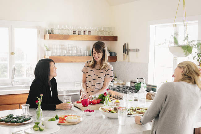 Women in a kitchen preparing lunch — Stock Photo