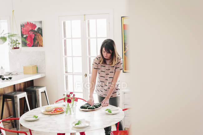 Woman laying a table — Stock Photo