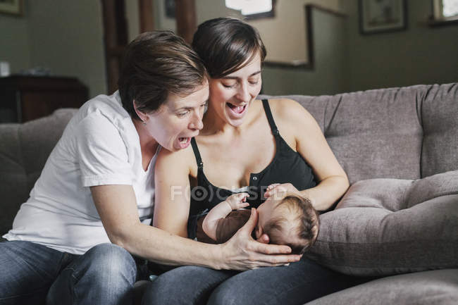 Mujeres jugando con su bebé niña . - foto de stock
