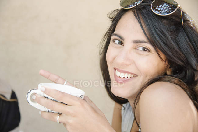 Woman holding a cup. — Stock Photo