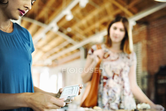 Two young women in a shop — Stock Photo