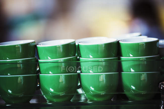 Green coffee cups stacked up. — Stock Photo