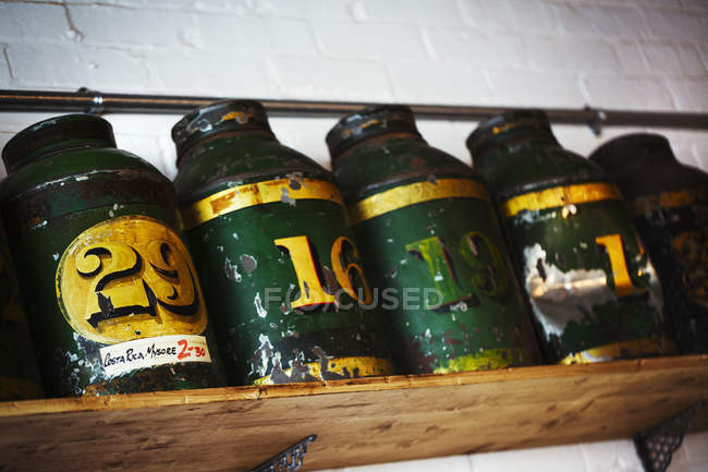 Row of coffee tins on a shelf. — Stock Photo