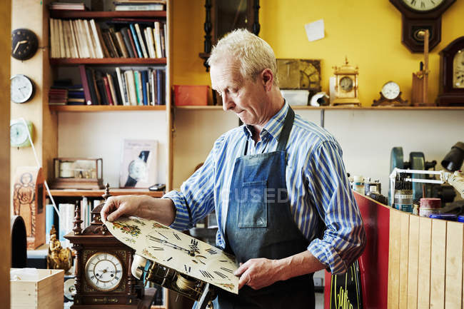 Clockmaker viewing his work — Stock Photo