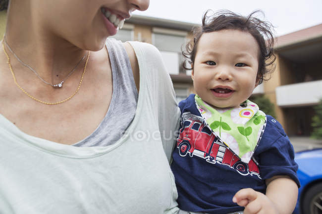 Mother carrying her baby boy. — Stock Photo