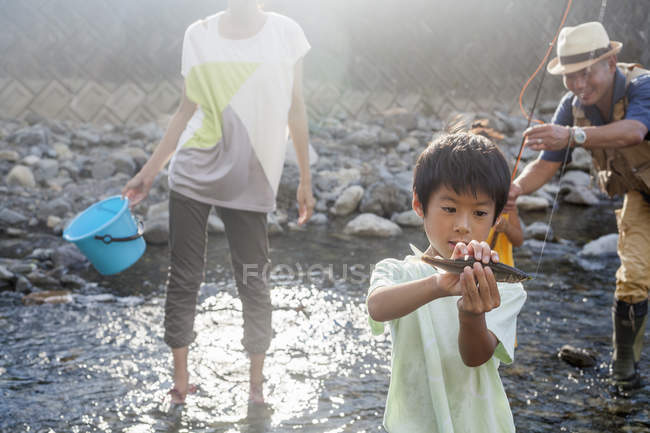 Japanese Family fishing in a stream. — Stock Photo