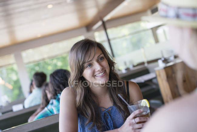 Woman sitting at a table in a diner — Stock Photo