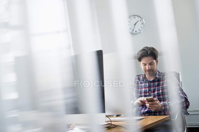Businesspeople leaning over a digital tablet — Stock Photo