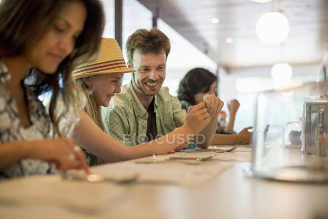 Friends sitting at the bar in a diner — Stock Photo