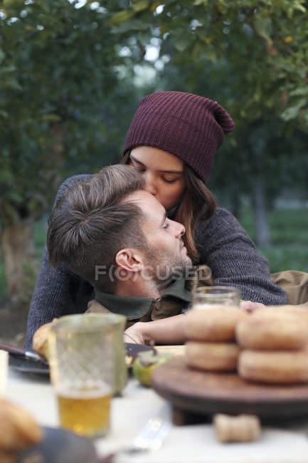 Couple embracing in Apple orchard — Stock Photo