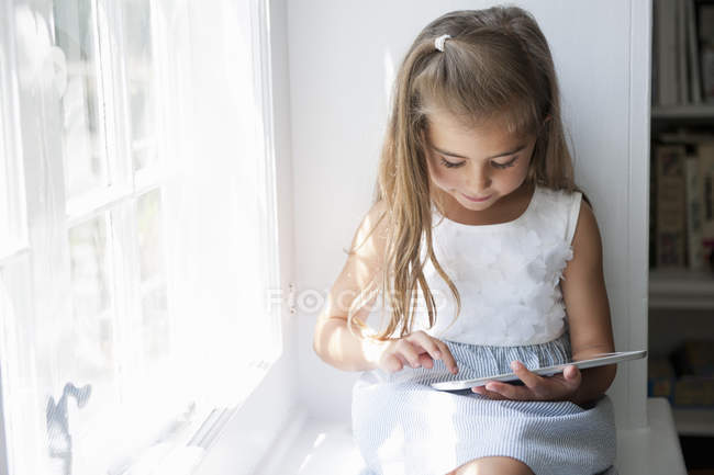 Girl using a digital tablet. — Stock Photo