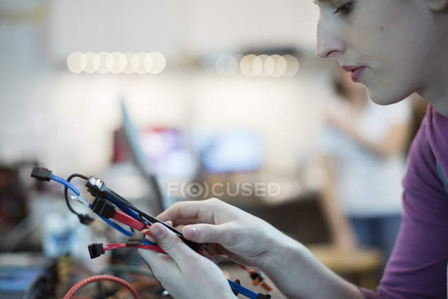 Woman using connecting cables and usb — Stock Photo