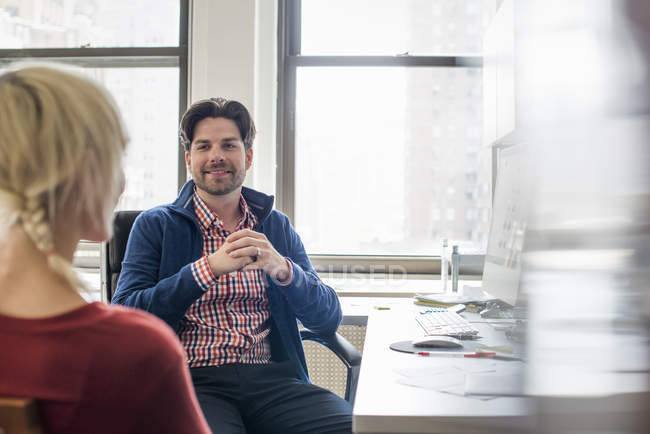 Man and woman in an office — Stock Photo