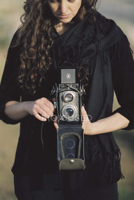 Woman taking a picture with an old camera. — Stock Photo