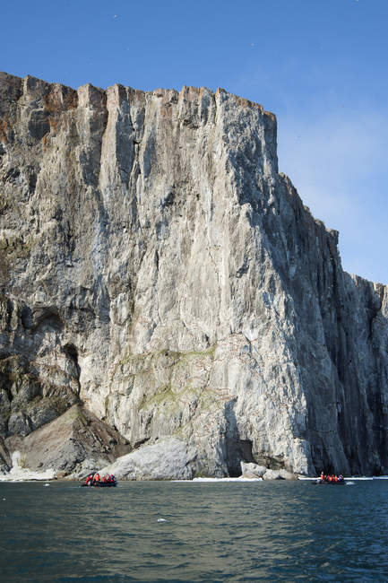 Zodiac boats along the cliffs — Stock Photo