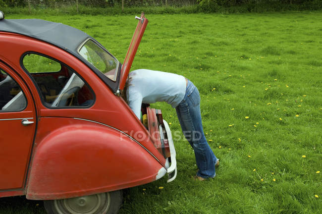 Person leaning in to the boot — Stock Photo
