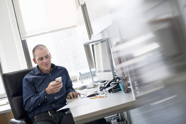 Man sitting at an office desk — Stock Photo