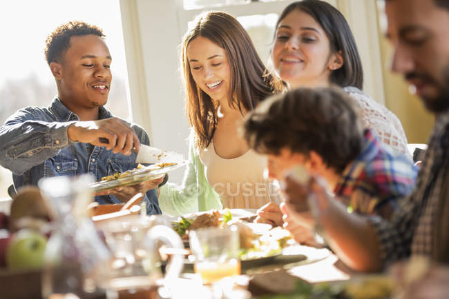 Erwachsene und Kinder sitzen an einem Tisch — Stockfoto
