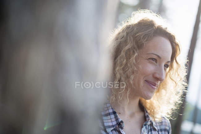 Woman walking in shade of trees — Stock Photo