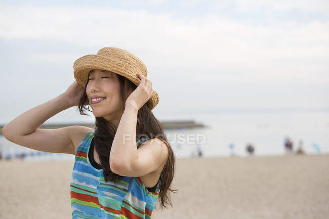 Young asian woman in hat — Stock Photo