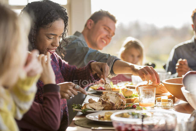 Adults and children, seated around a table — Stock Photo