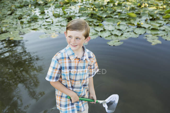 Молодий хлопчик стоїть на мілкій воді — стокове фото