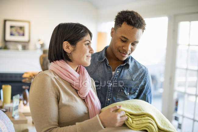 Smiling couple standing in living room — Stock Photo