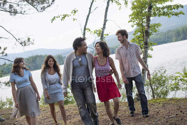 People enjoying walk by lake — Stock Photo