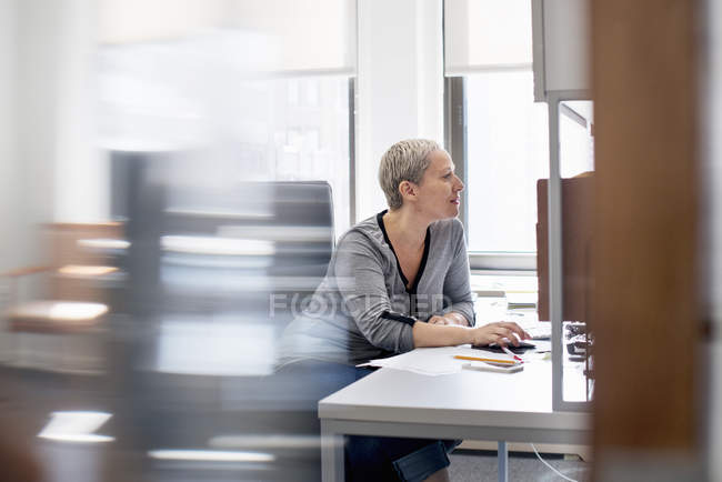 Mujer usando un ratón de ordenador . - foto de stock