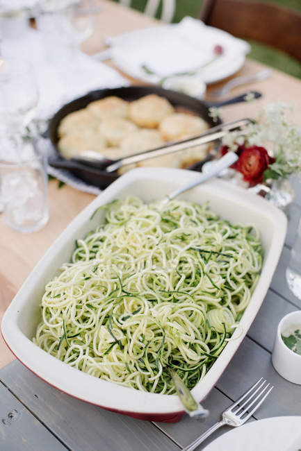 Large dish with a salad of courgette — Stock Photo