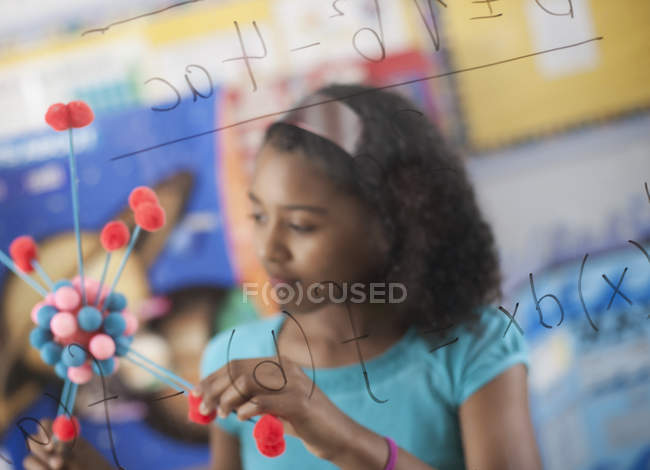 Girl holding a molecular structure — Stock Photo
