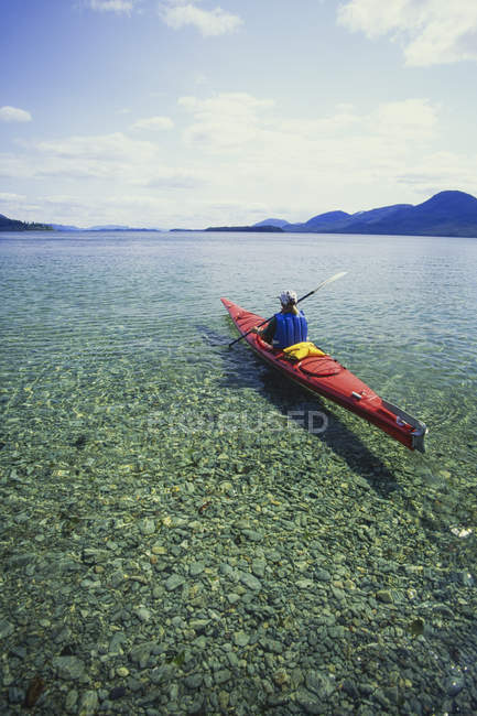 Hombre en un kayak de mar - foto de stock