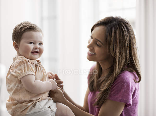 Mother holding little daughter — Stock Photo