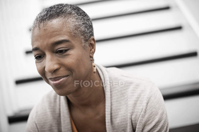 Woman sitting on the stairs at home. — Stock Photo