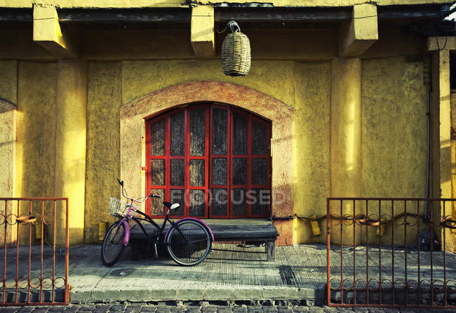 Bicycle parked outside the door — Stock Photo