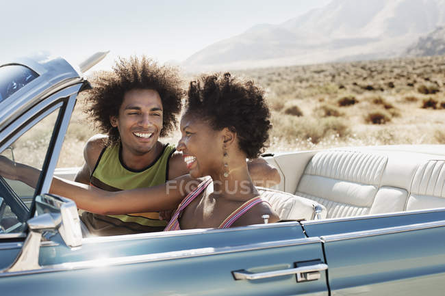 Couple in a pale blue convertible — Stock Photo