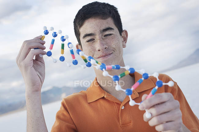 Teenager holding molecular structure — Stock Photo