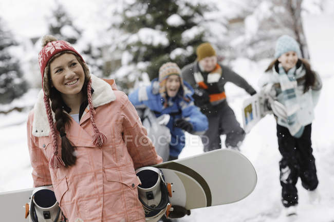 Irl carrying a snowboard — Stock Photo