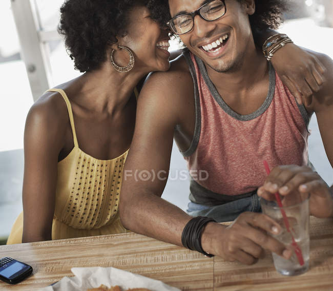 Couple sitting together hugging — Stock Photo