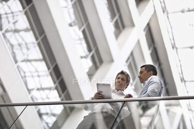 Business colleagues standing by a railing — Stock Photo