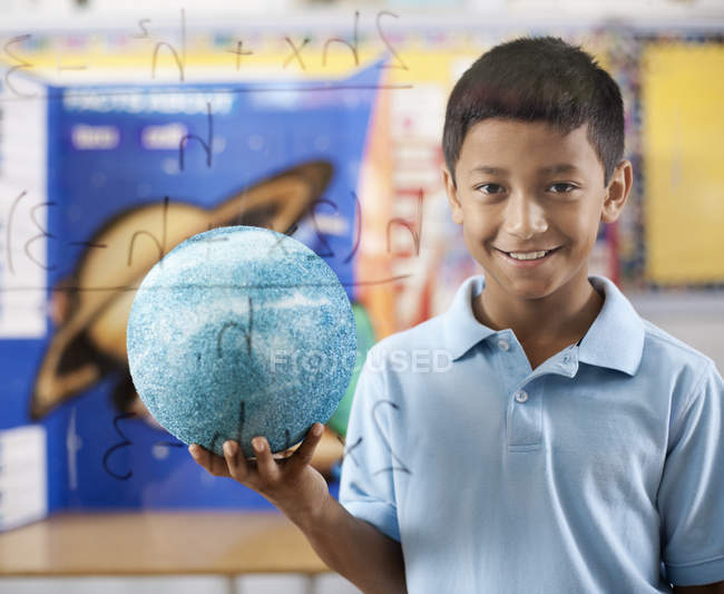Boy holding a globe. — Stock Photo