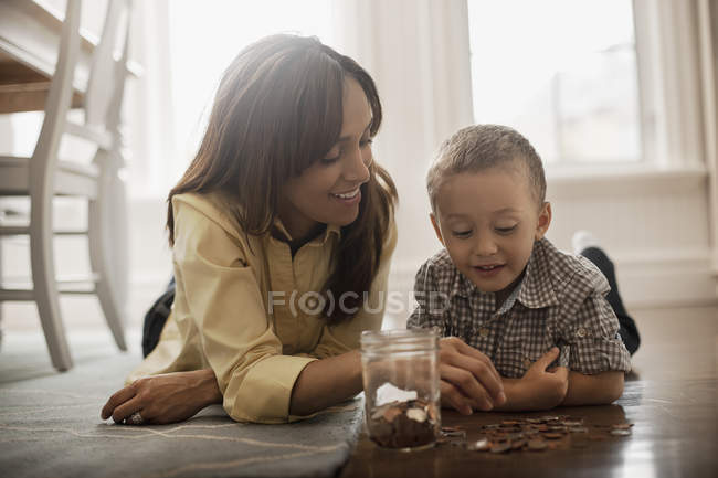 Woman and a child lying on the floor — Stock Photo