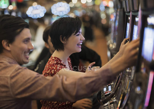 Les gens qui jouent aux machines à sous dans un casino . — Photo de stock