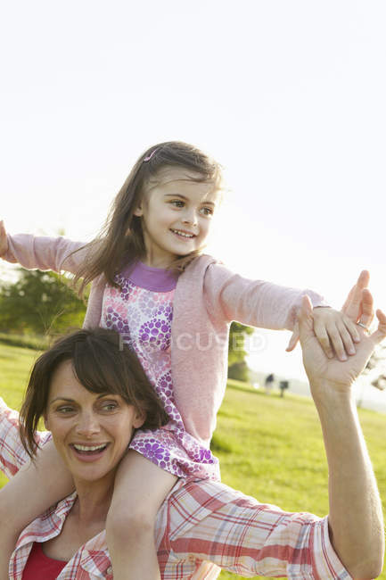 Mother carrying her daughter — Stock Photo
