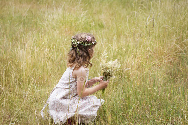 Young girl with flowers — Stock Photo