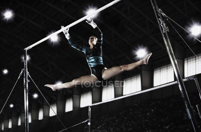 Woman performing on parrallel bars — Stock Photo