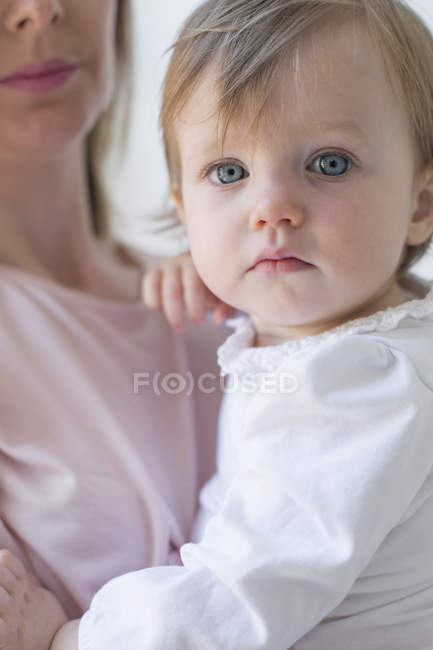 Young girl in her mother's arms. — Stock Photo