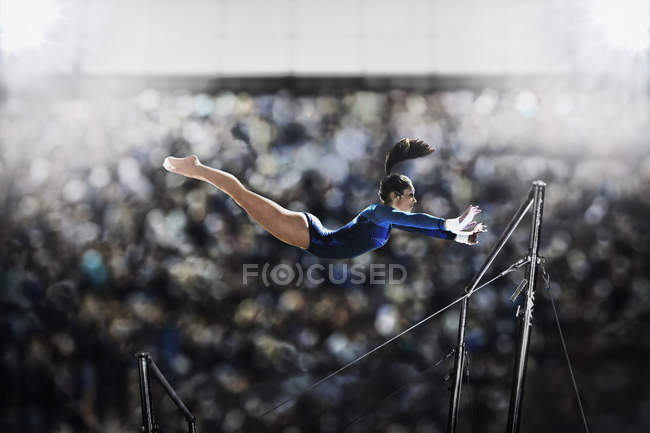 Young woman performing on parallel bars — Stock Photo