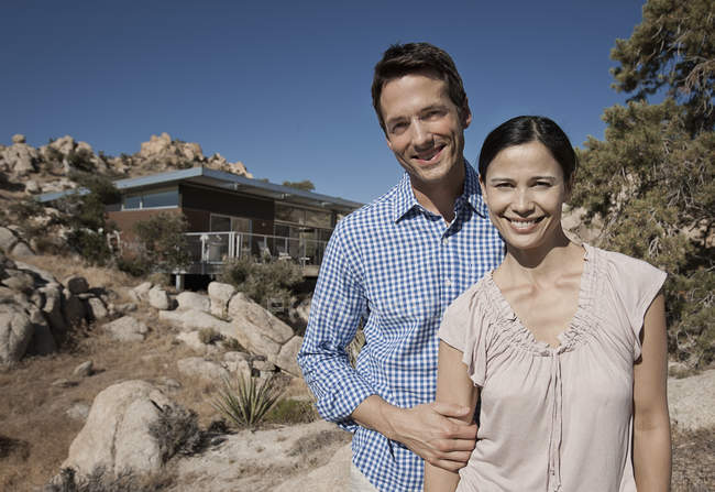 Couple and the view of their eco home — Stock Photo