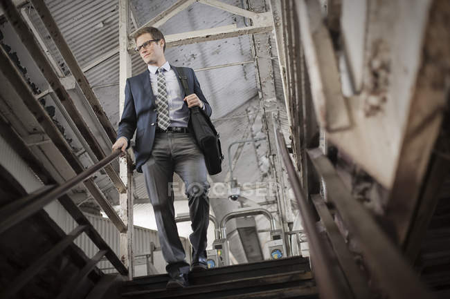 Businessman walking down stairs — Stock Photo